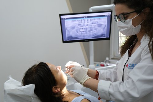 mcan dental's dentist treating the patient 